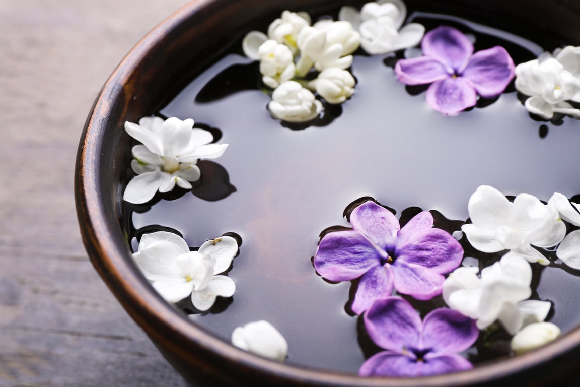 Lilac Flowers in a Bowl on Wooden Background